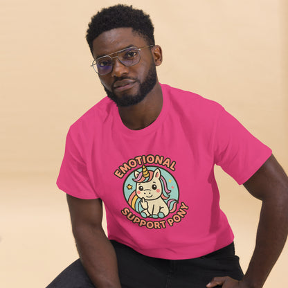 Person wearing a pink t-shirt with a unicorn graphic and text on a beige background