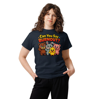 A woman modeling a navy blue t-shirt with a colorful graphic that reads 'Can You Say BURNOUT?' above four cartoon animals (a bear, a bunny, a duck, and a pig). She is wearing black pants against a plain white background.