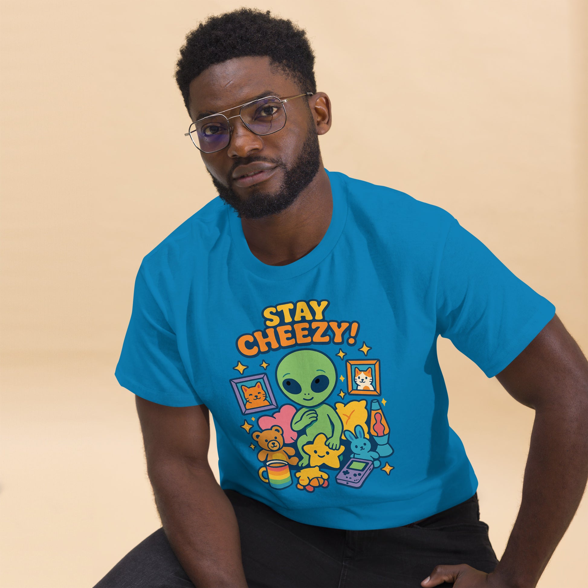 Man wearing a blue t-shirt with 'Stay Cheezy!' graphic design on a beige background