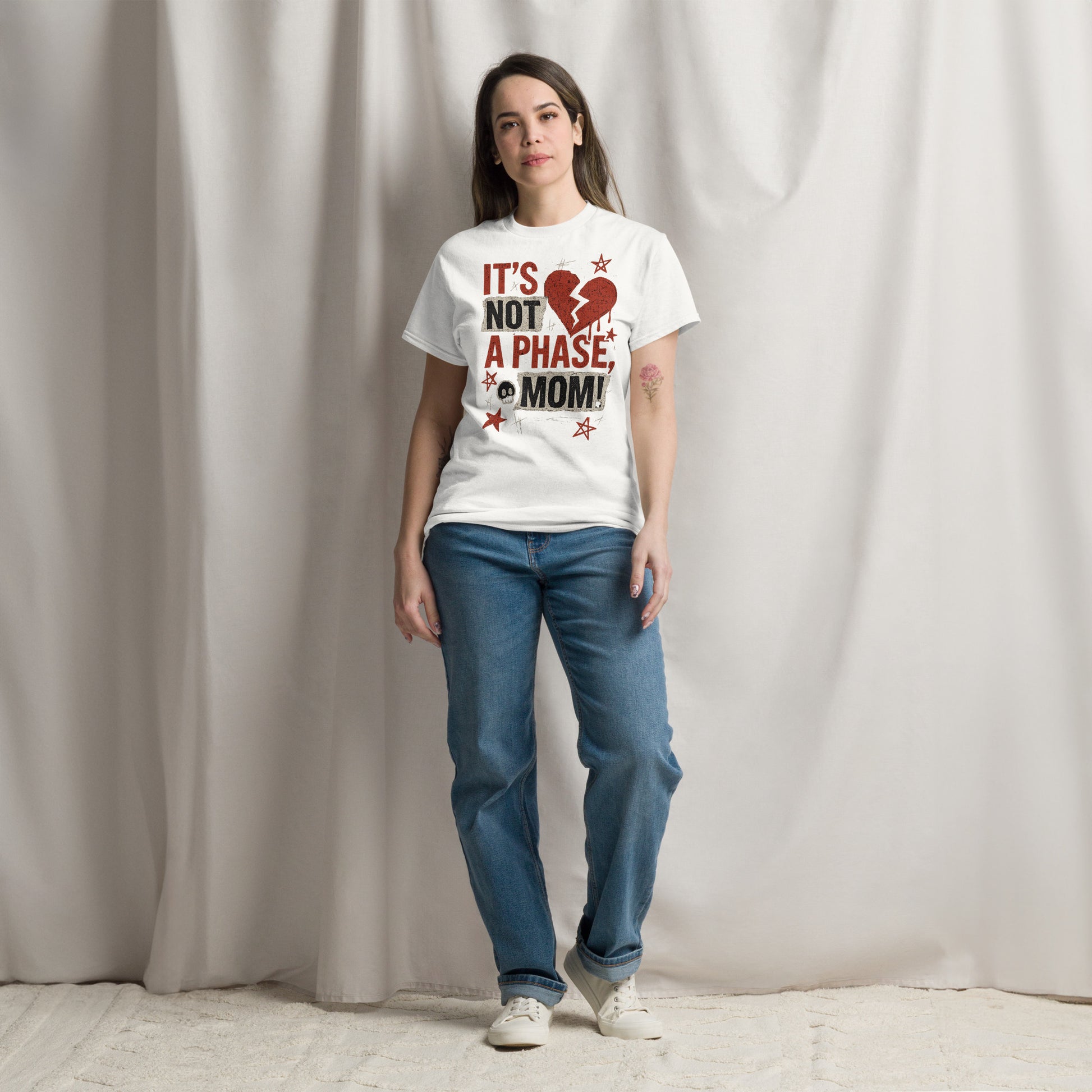 Woman wearing a white t-shirt with a red and black graphic and text, standing against a plain background.