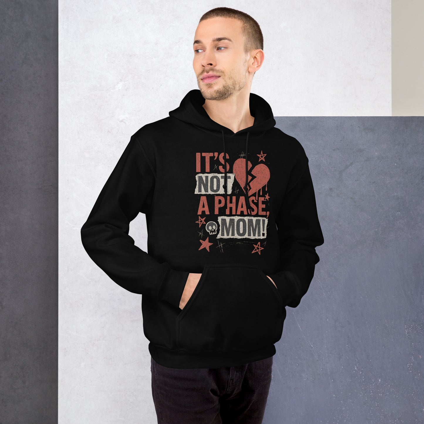 Man wearing a black hoodie with text and graphic design against a gray background