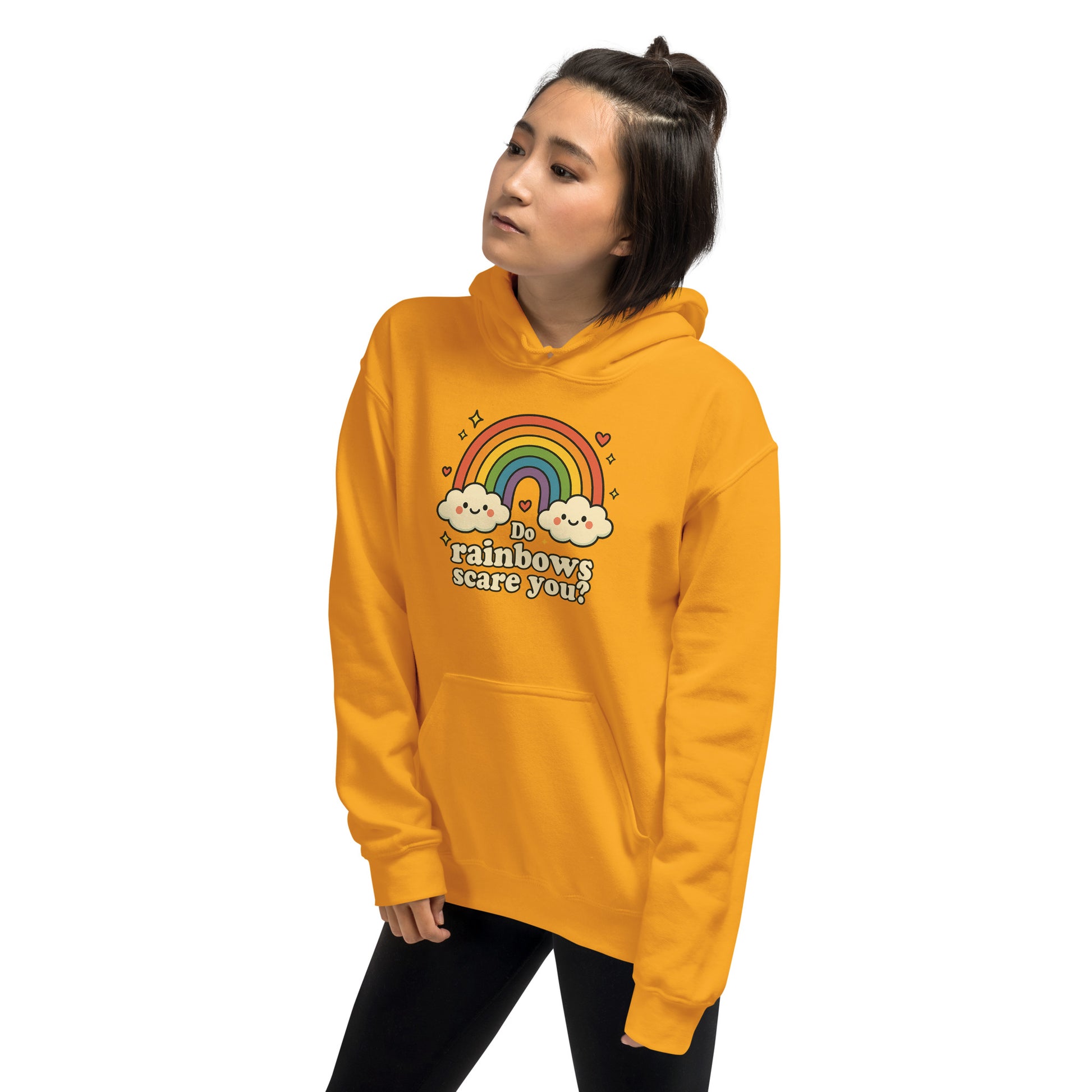 Person wearing a yellow hoodie with a rainbow and cloud design on a white background