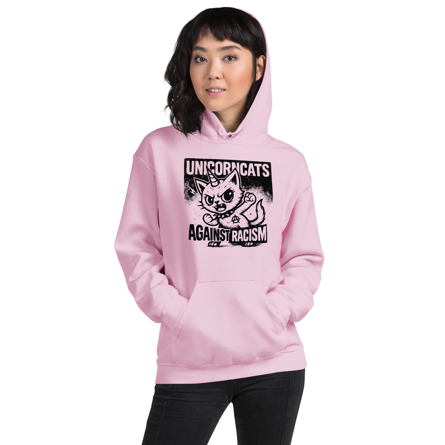 Woman wearing rose hoodie with a unicorncat and a text reading "Unicorncats against racism"