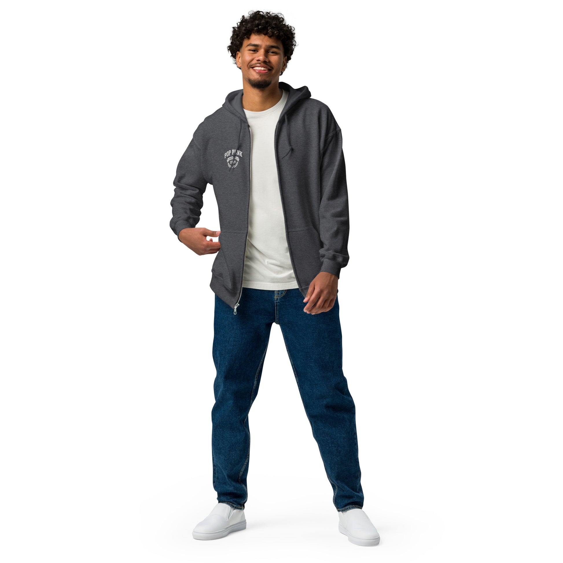 Man wearing a gray hoodie, white t-shirt, blue jeans, and white sneakers on a white background