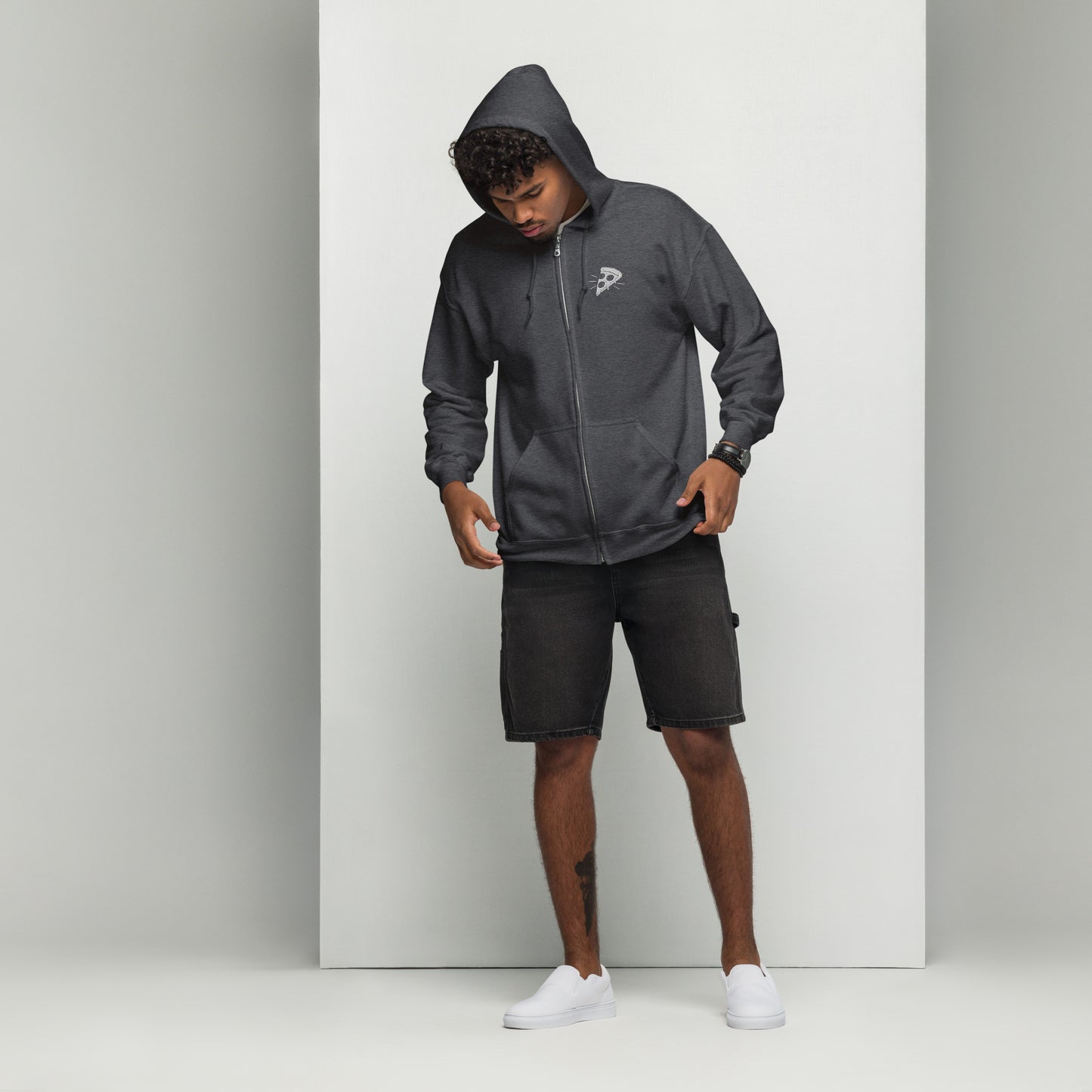 Person wearing a gray hoodie and shorts on a white background