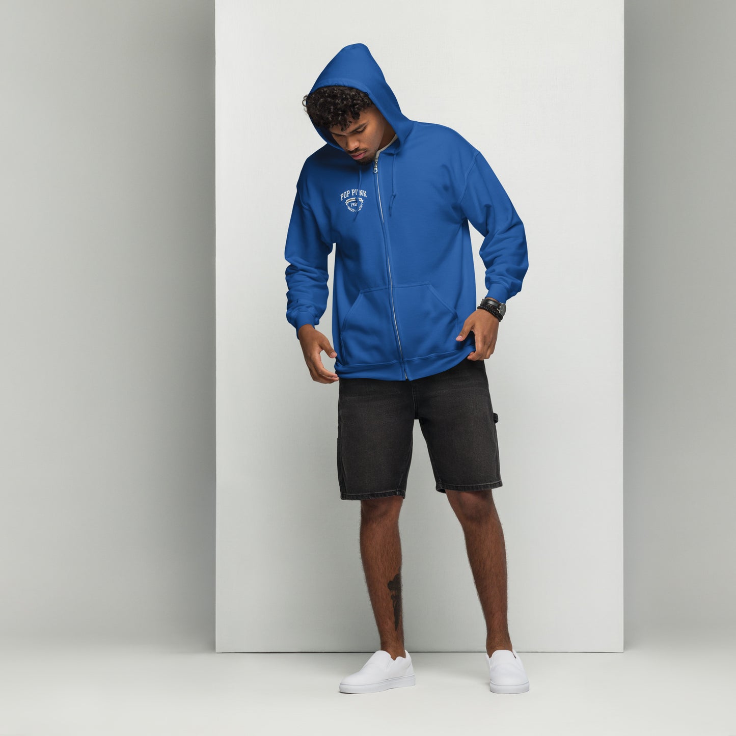 Person wearing a blue hoodie with a logo on a white background