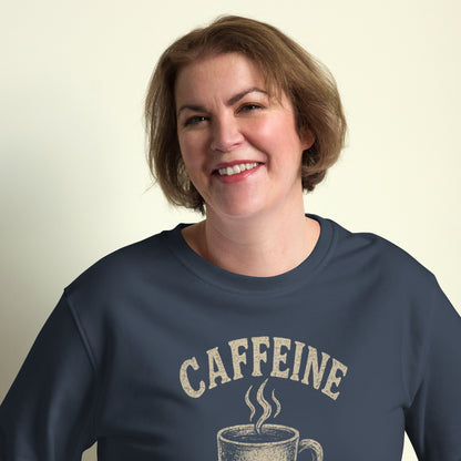 Person wearing a navy blue sweatshirt with 'CAFFEINE' and a coffee cup graphic on a beige background