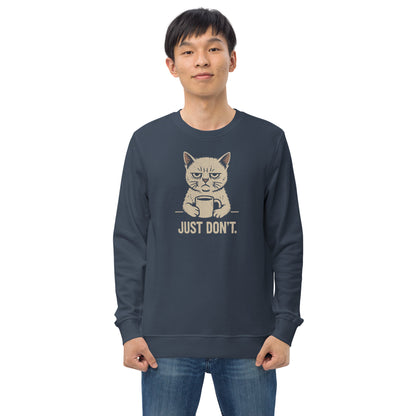 Person wearing a navy blue sweatshirt with a graphic of a cat and text 'JUST DON'T.' on a white background